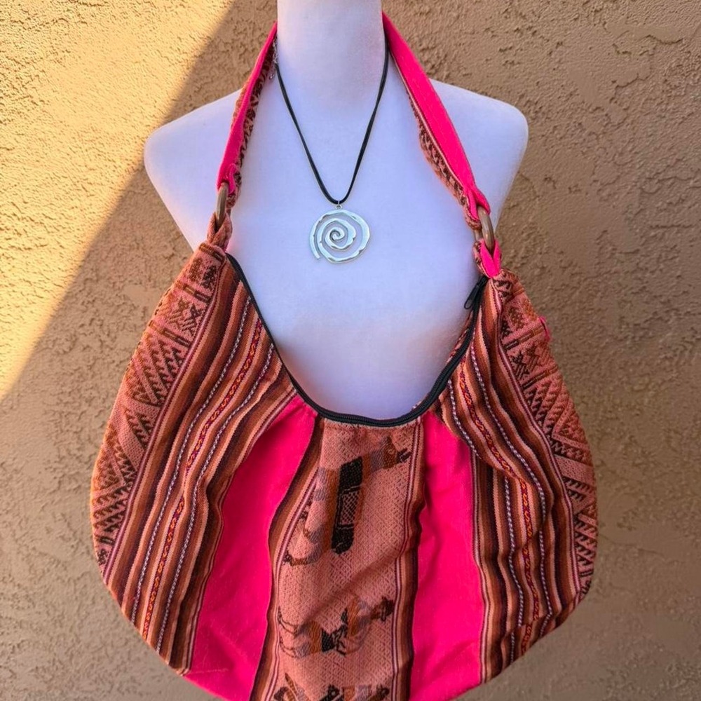 Pink and orange hobo bag with llamas